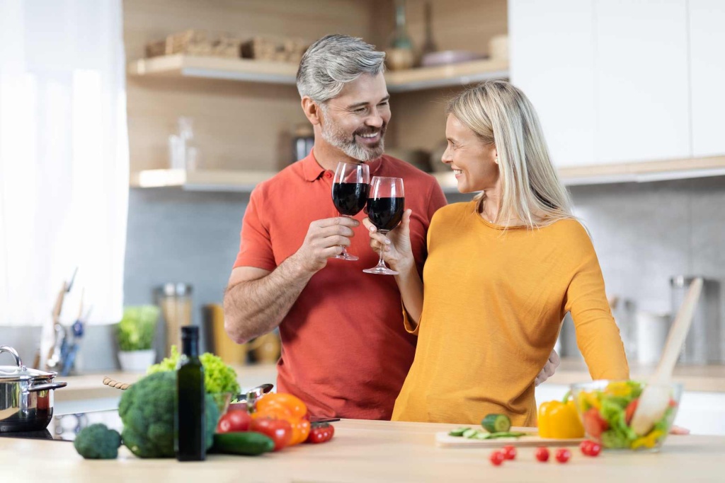 happy-middle-aged-couple-cooking-drinking-red-wine-kitchen (1).jpg